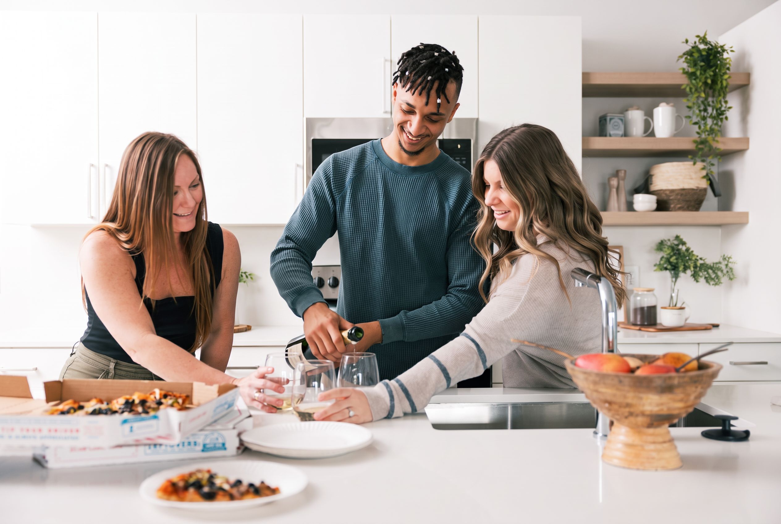 Residents celebrating together in the kitchen of their Commercial Northwest home